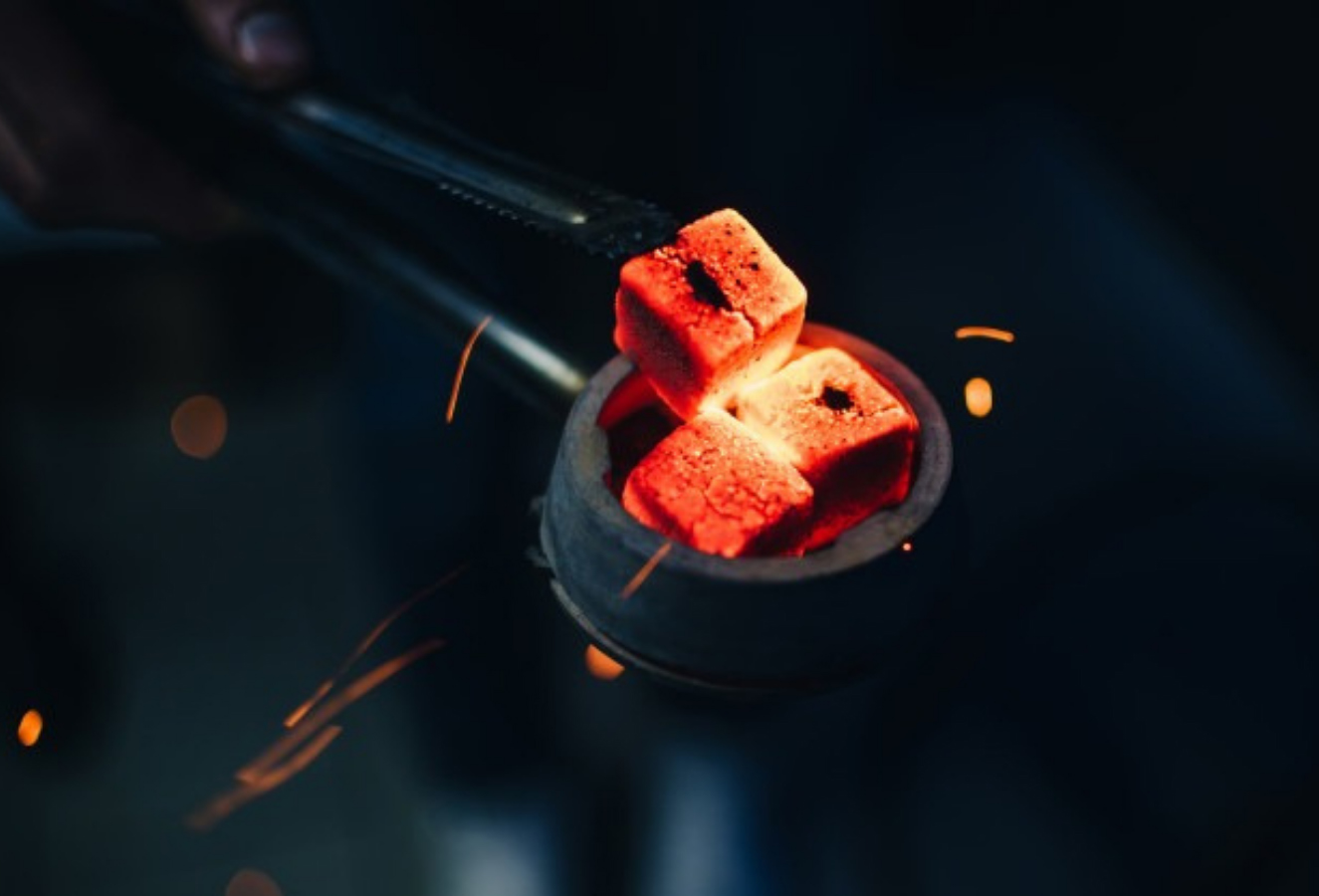Glowing coconut charcoal cubes on a shisha bowl